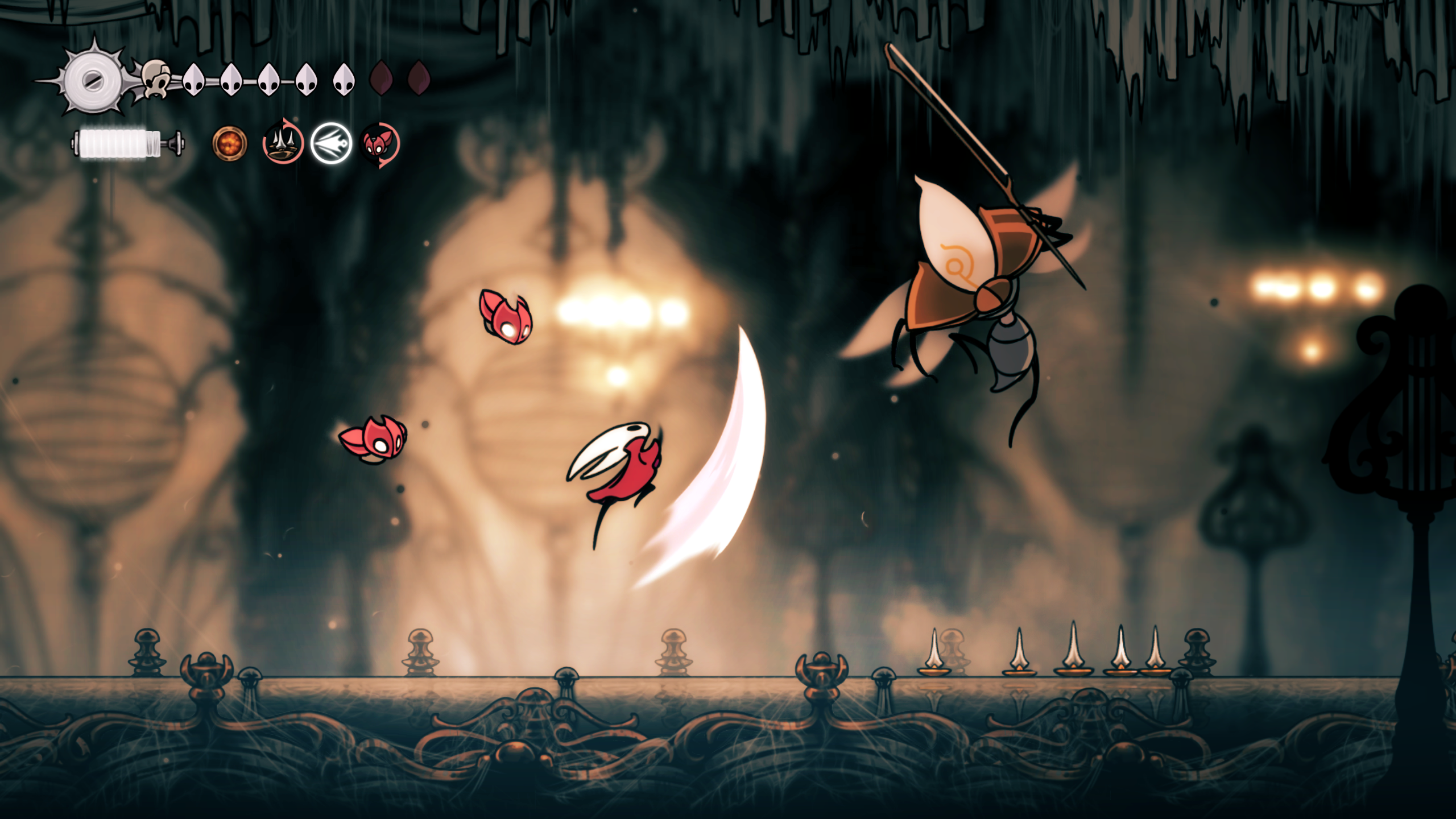 Dark underground chambers with Hornet performing acrobatic combat moves against flying enemies